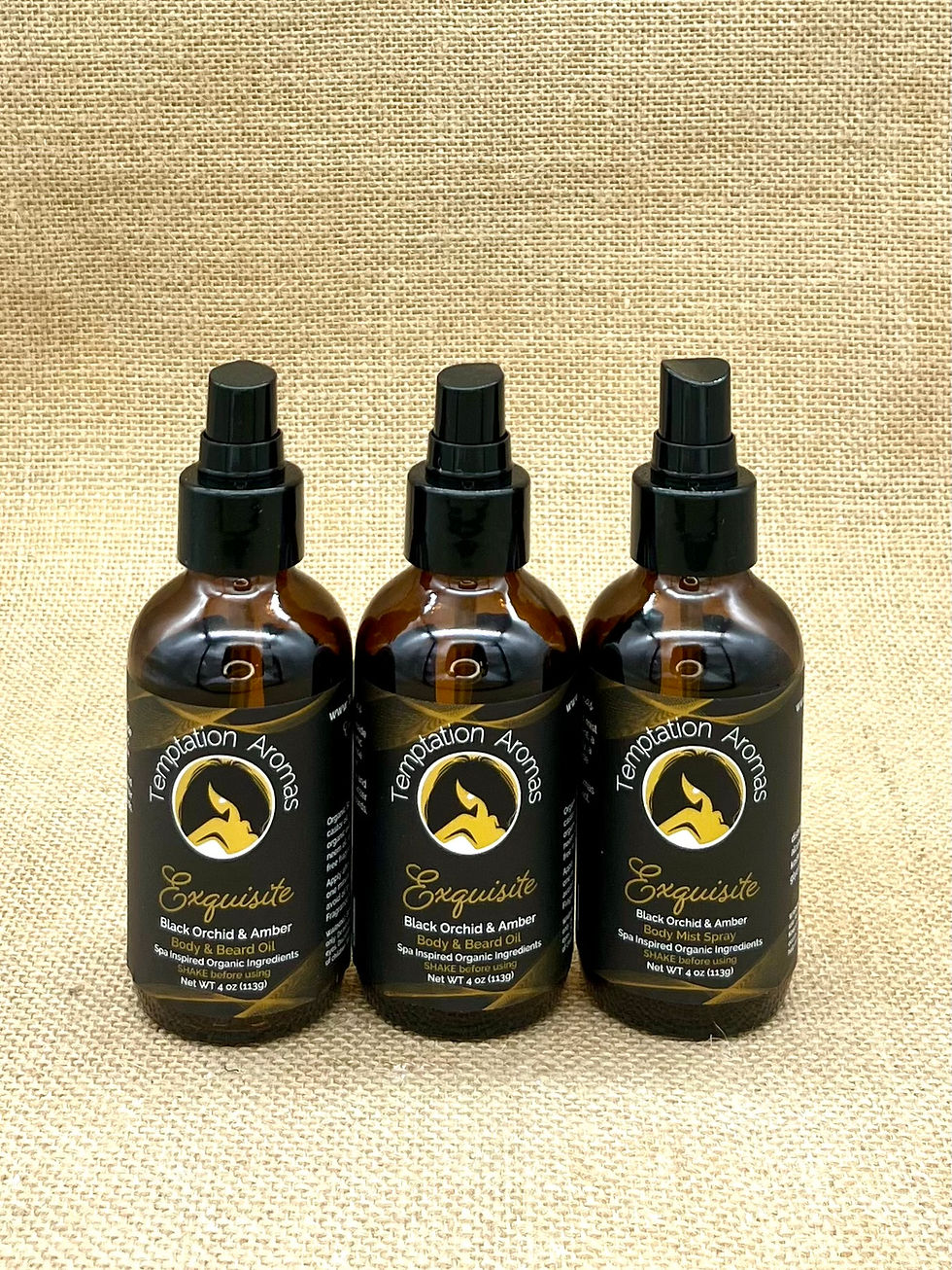 Thumbnail: Exquisite warm orchid 4oz bundle with two amber oil bottles and one body spray mist on rustic burlap