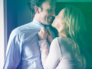 A happy husband and wife sharing a cozy, affectionate moment together.