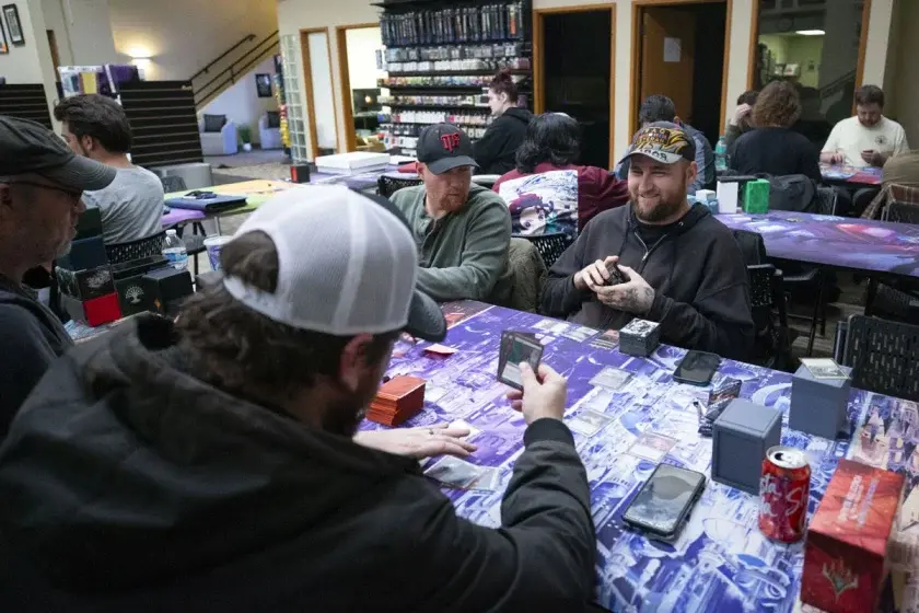Army veteran Kevin Coleman, right, laughs as he plays Magic: The Gathering with fellow veterans in a group called Veterans: The Gathering, Nov. 25, at Core Cards and Collectibles. 