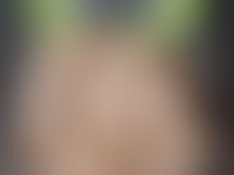 Glass container of square crackers on a dark countertop beside a green lid with "ziploc" text. Crackers are light brown and well-arranged.