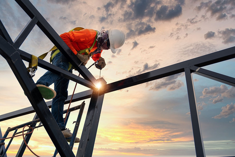 welder working on a metal frame outside