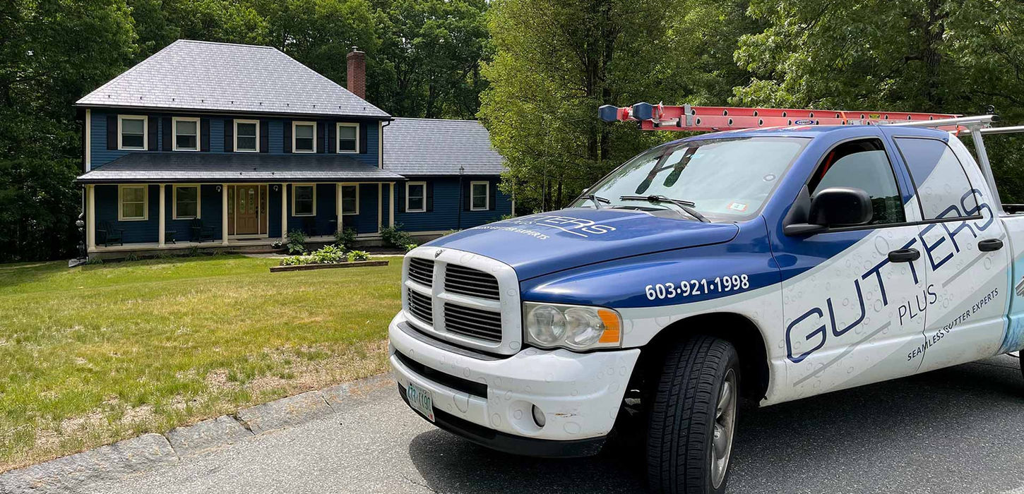 Gutters Plus pickup parked in front of house