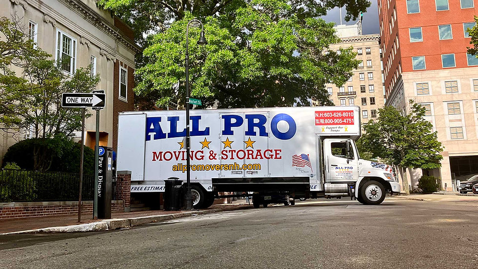 White All Pro moving truck on city street