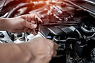 Mechanic performing injector testing on a car engine