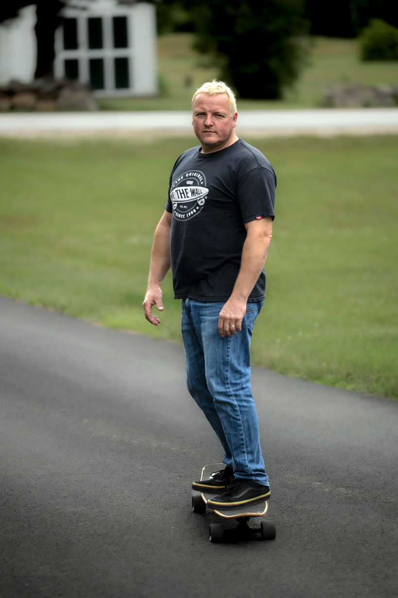 Man in black t-shirt riding skateboard