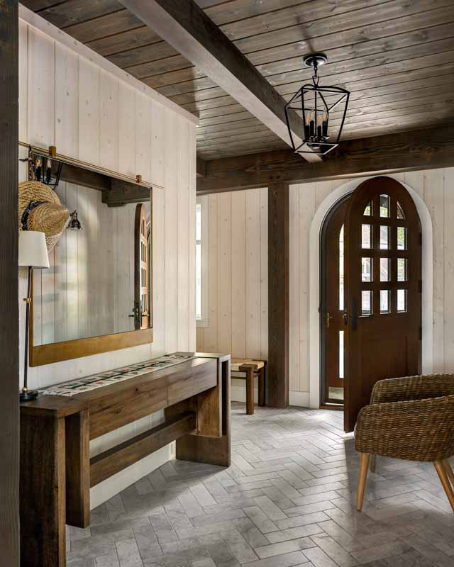 Interior entryway with Keyhole front door and rustic chandelier in Silver Lake, NH