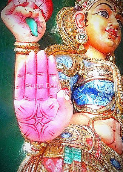 Sri Mariamman, 2007. Best Singapore travel photography. Hindu temple. The hands of Lakshmi representing Purusartha, or the four proper aims in life: dharma, artha, kama, and moksha. 'Man consists of desire, As his desire is, so is his determination, As his determination is, so is his deed, Whatever his deed is, that he attains.' —from the Brihadaranyaka Upanishad, 7th century BC