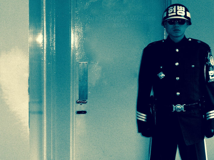 Portal, 2006. Captured by NYC photographer Stuart Douglas Williams while visiting Korea's DMZ. Beyond this door: The North. The paint has worn thin on the wall where southern soldiers brace their brethren with one foot up for leverage so as to prevent them from being physically ripped from their country.