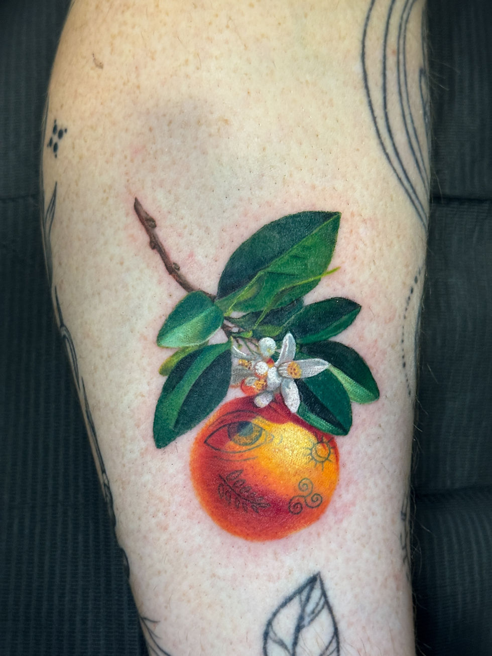 Ashley Casavant's unique orange tattoo, with apprentice tattoos, done at the Okanagan Tattoo Show