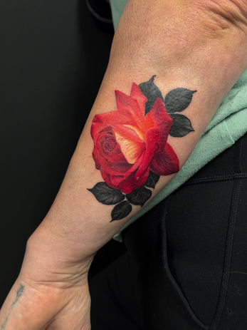 Red colour realism rose tattoo on forearm - Ash & Ink Tattoo Studio, Kelowna BC