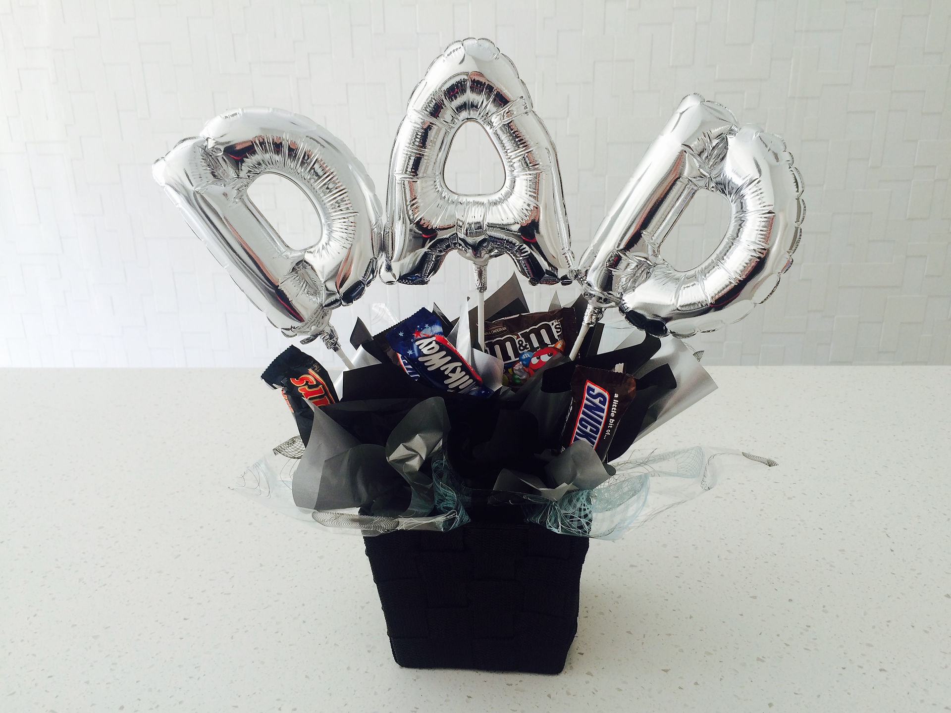 DAD letter balloons on sticks add to a basket and loads of sweets.