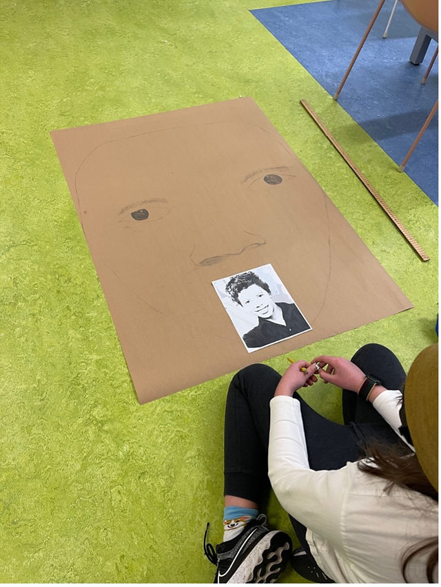 child drawing a portrait for BHM