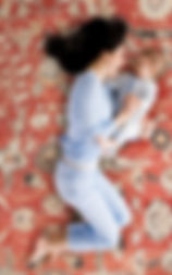 mother and baby laying on handwoven rug