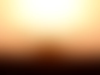 Silhouette of a person with arms raised in a field against a golden sunrise, creating a serene and uplifting mood.