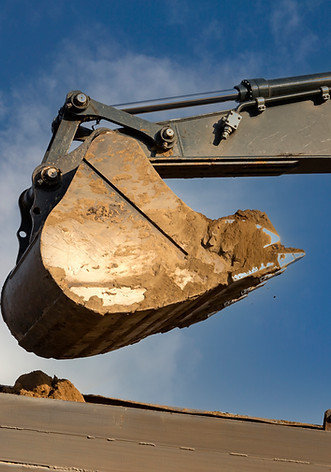excavator-bucket-pours-soil-into-truck.jpg