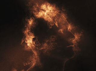 Silhouette of a human head formed by swirling orange flames on a dark background, creating an ethereal and intense atmosphere.