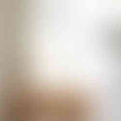 Pair of round wall sconces in alcove, complementing ottoman by mirror, for both lighting and decor