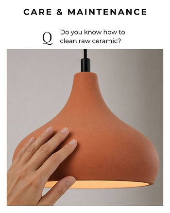 Hand touching a textured terracotta-colored raw ceramic pendant lamp to show material quality.
