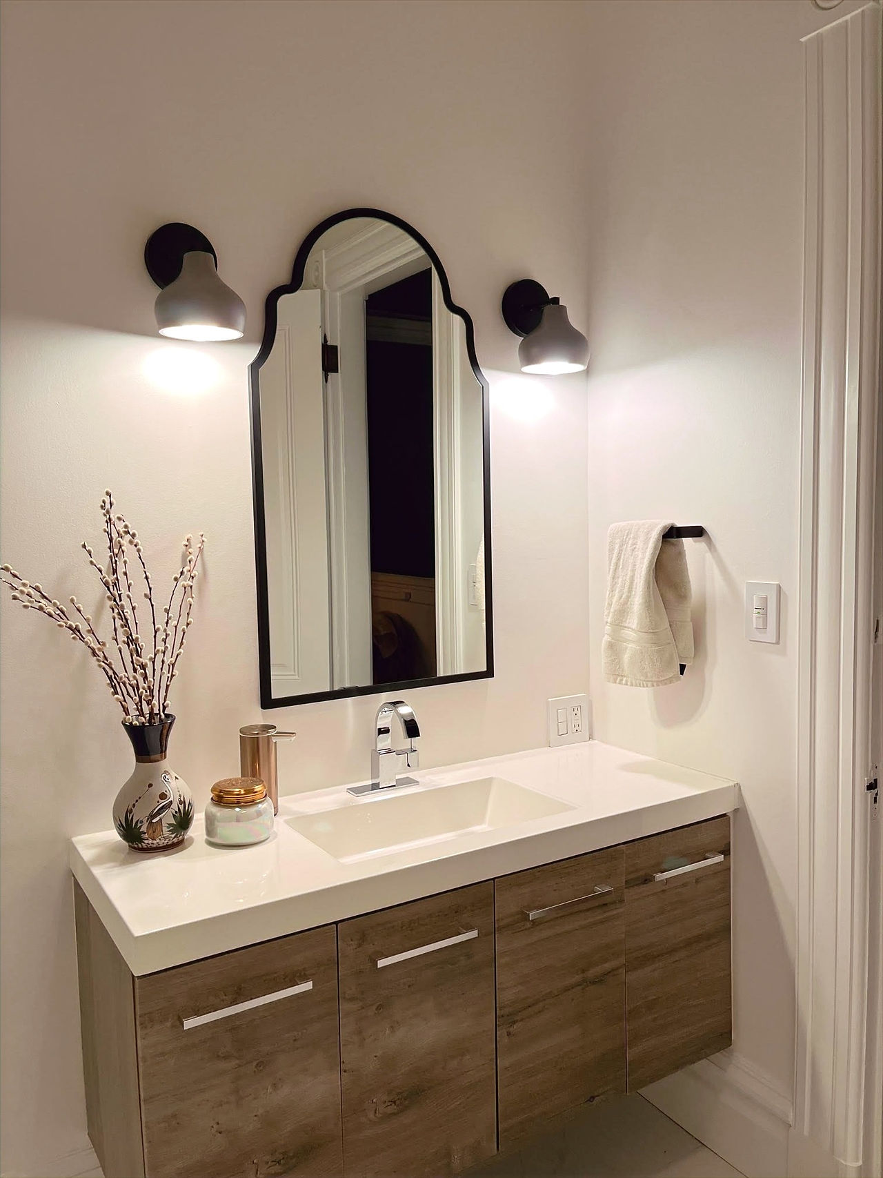 An image from customer review shows Naaya Wall Bell light fixtures for bathroom vanity