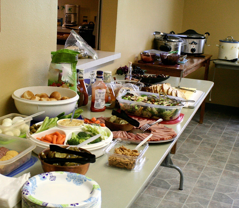 images shows a communal lunch table spread with a shared meal