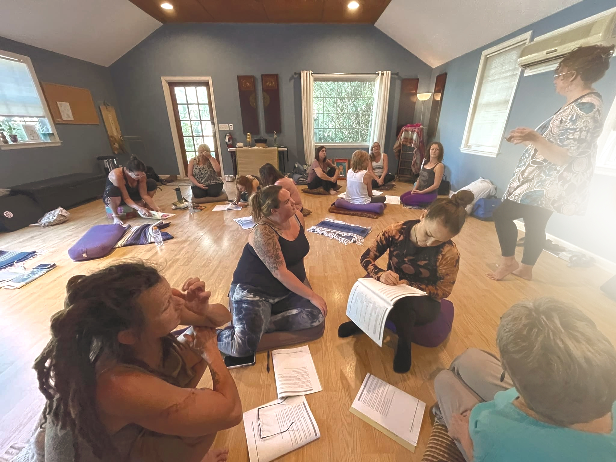 A woman in a cozy setting, practicing self-care with a hot beverage and journal, embodying relaxation and wellness.