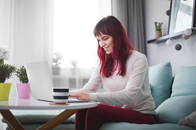 young-smiling-woman-working-at-home-usin