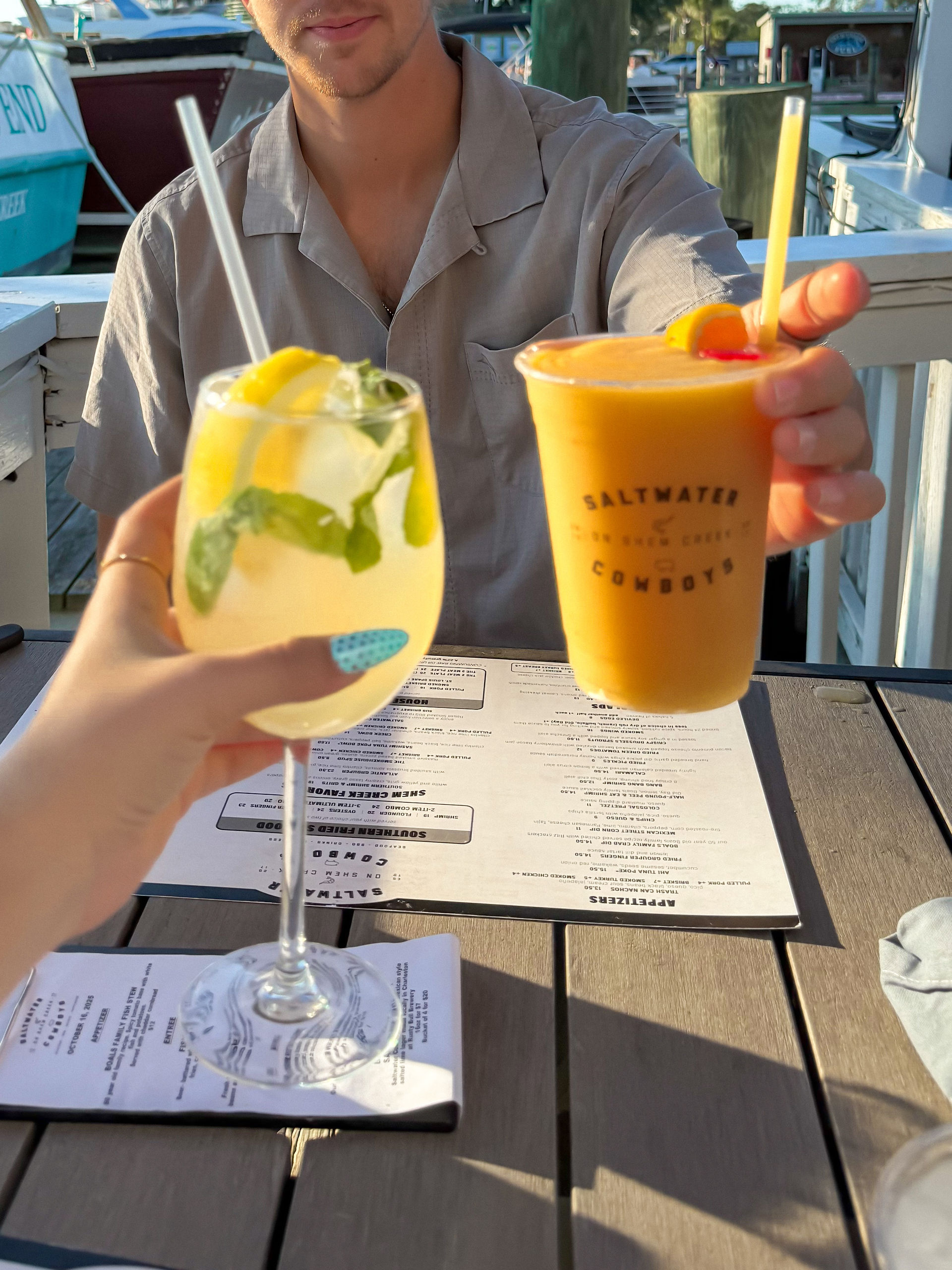 a Hugo spritz and Aperol spritz held by two hands 