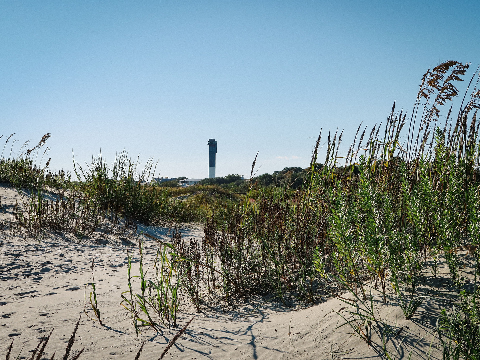 lighthouse on the horizon of a beach