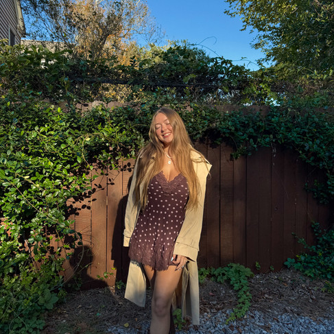a girl wearing a brown polka dot mini dress and trench coat