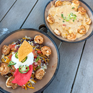 a shrimp burrito bowl and shrimp and grits plate