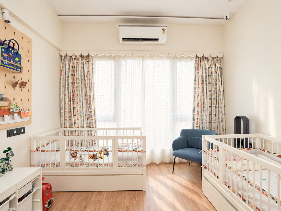Full view of a twins' room in Parel with two beds, daylight, and a colour accent chair.