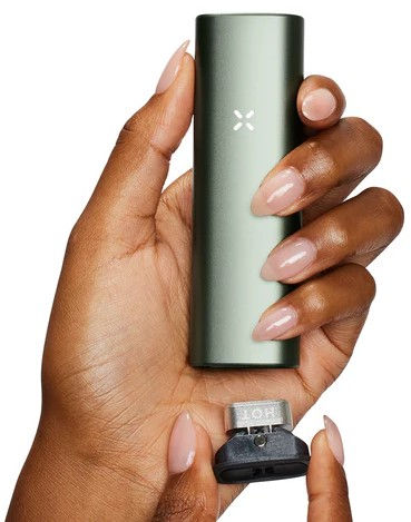 Hand holding a PAX portable vaporizer device, showcasing sleek design for a premium smoke-free experience