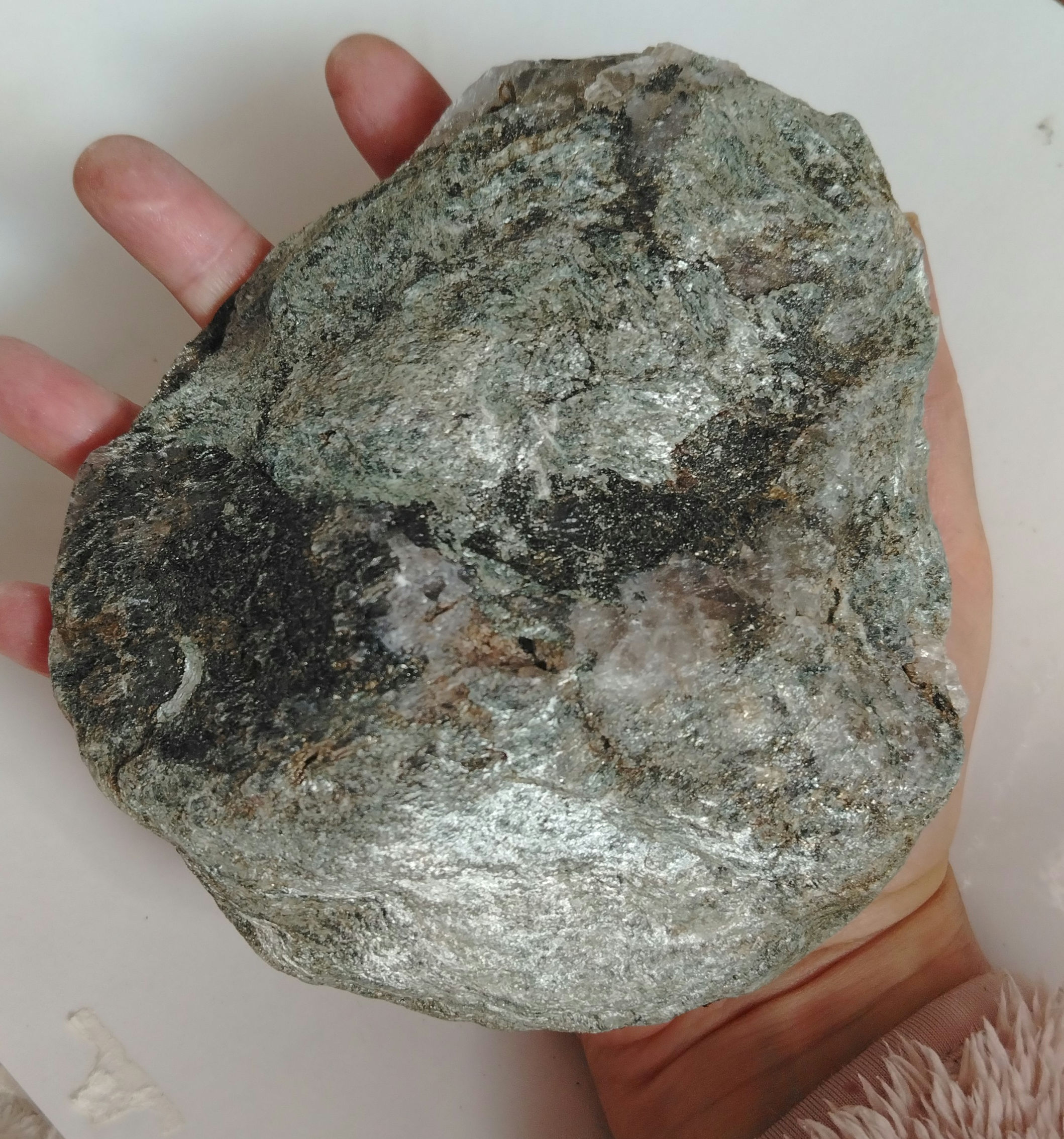 A large piece of Scottish quartz that has mica schist in golden green on it