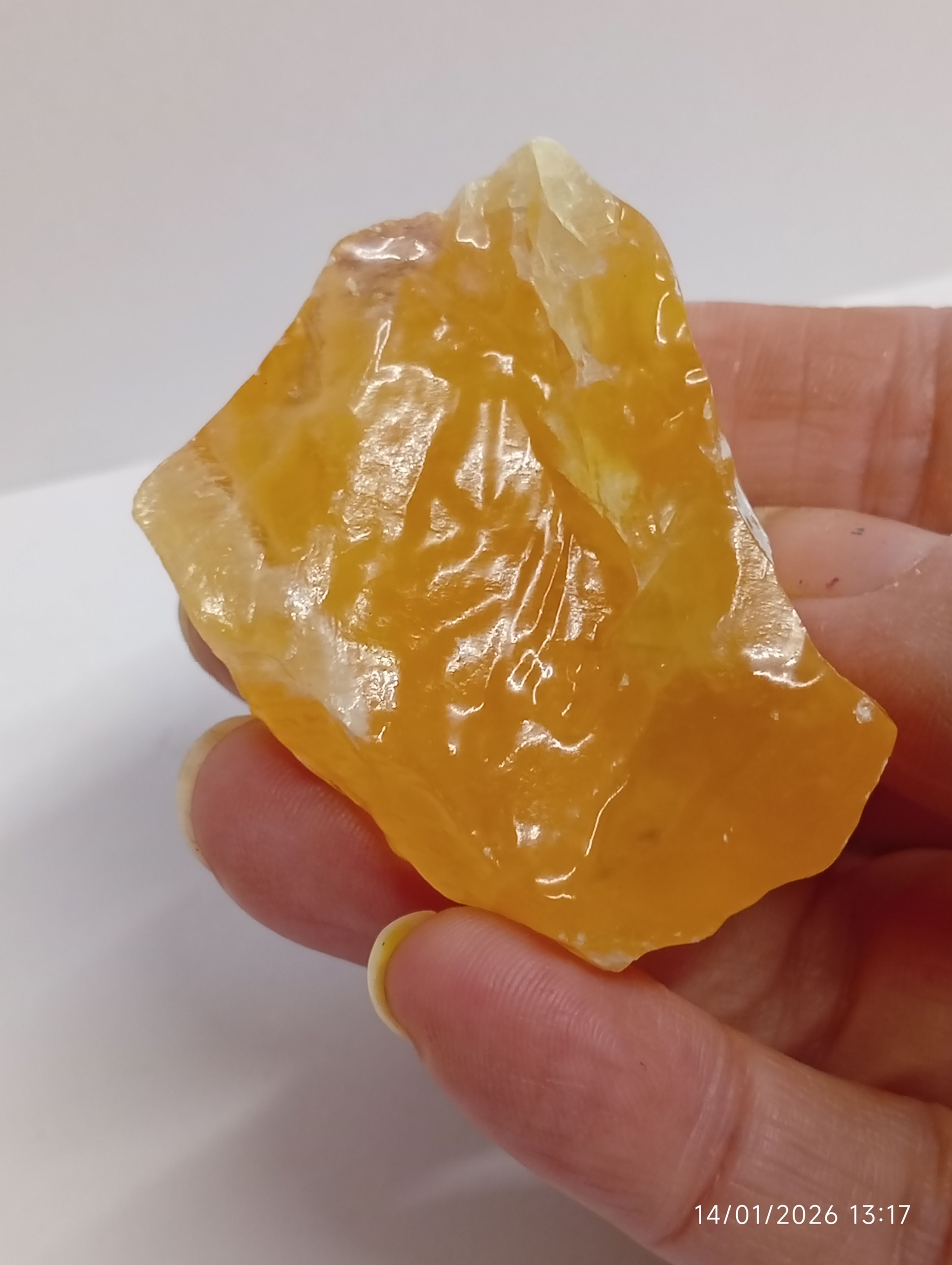 a glossy, waxy, juicy piece of honey calcite crystal