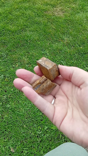 Miniature : A chunk of rough tiger's eye crystal supports an incense stick through a hole drilled into it.