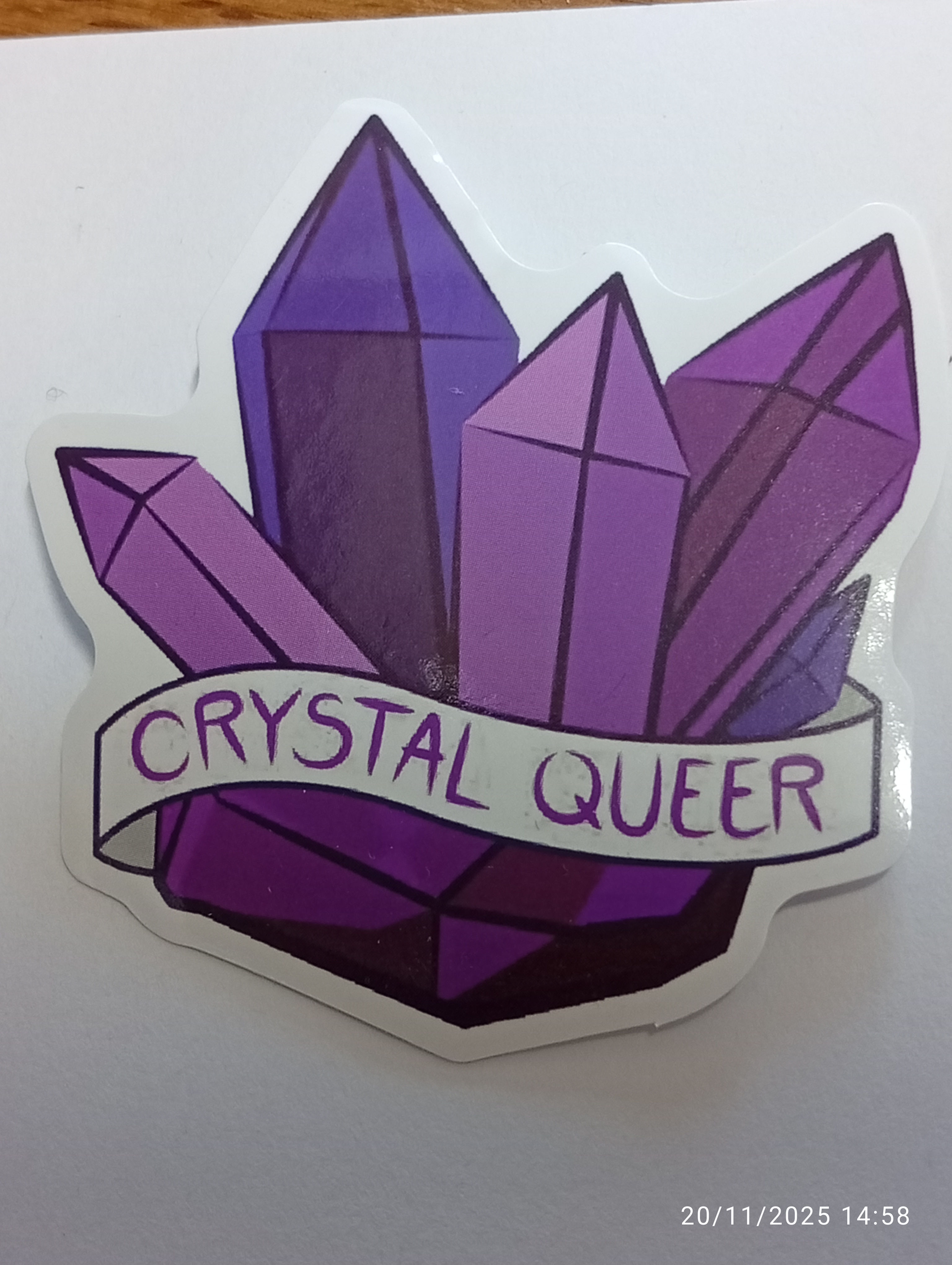 a sticker featuring purple crystals and the motto "crystal queer"