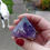 Thumbnail: A deep purple, large amethyst point with a little clay on the bottom.