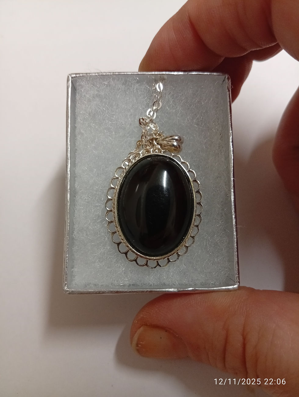 Thumbnail: a Whitby Jet pendant set in Sterling Silver with an 18 inch Sterling Silver plated chain, a silver box, and a note on origins