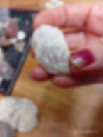 A piece of Calcite crystal which might be a point and has a smokiness to it