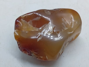 A shiny polished carnelian agate in orange and red.