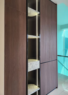 Tall built-in display shelves beside a glass partition