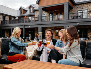 Group of friends cheersing drinks on patio