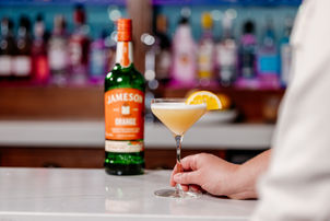 Cocktail and Jameson orange bottle.