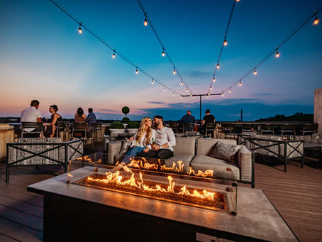 Couple sitting by fire on Rooftop