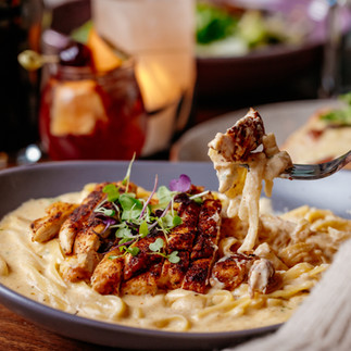 fork dipping into Chicken Alfredo Pasta
