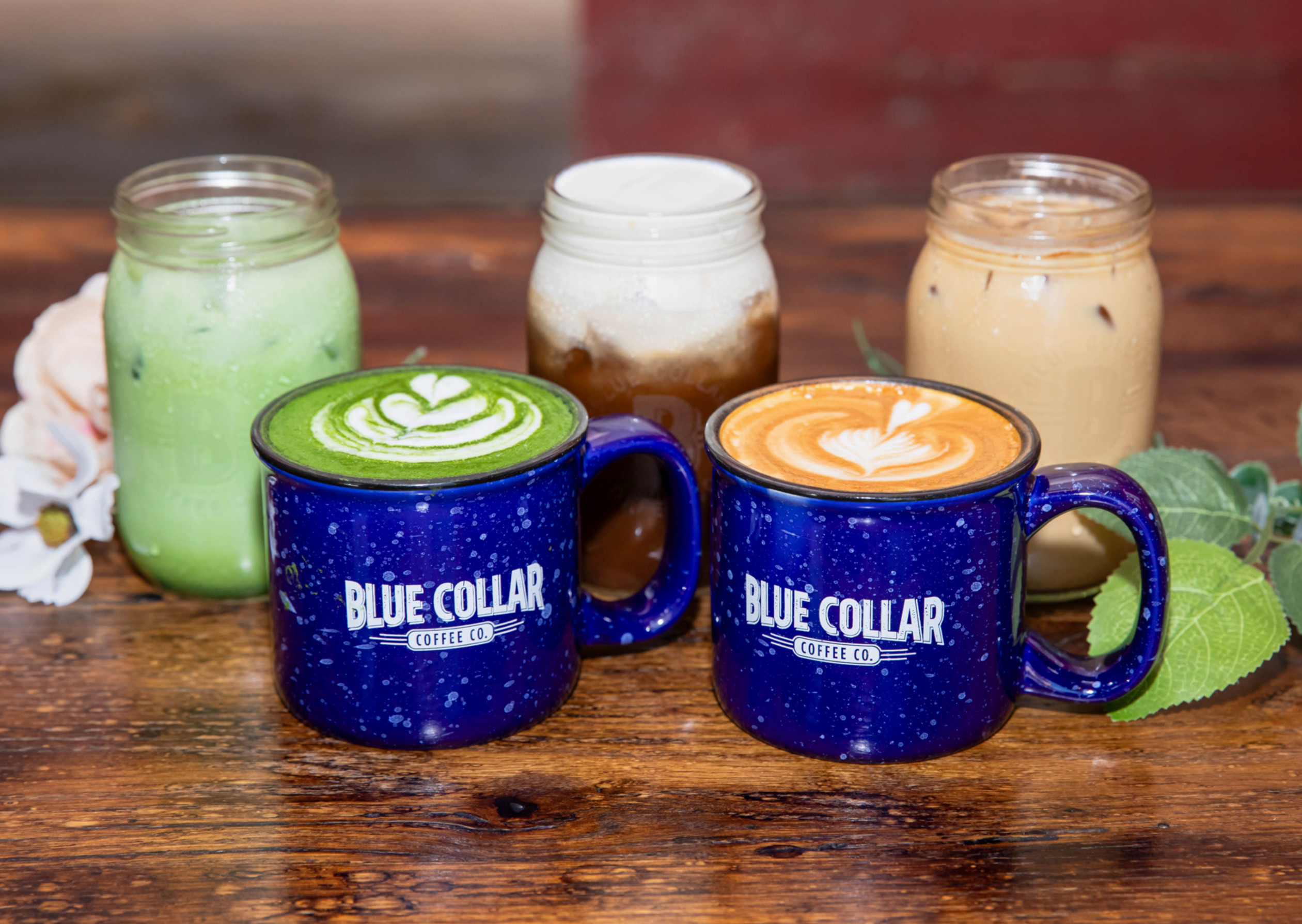 Blue Collar Coffee Signature Drinks featuring the Northwoods Latte, Campfire Cold Brew, and Sweet Bloom Matcha Latte