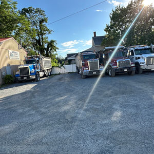 Monel and Sons trucks lined up at the shop.