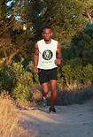 tank-top-mockup-of-a-man-running-in-natu