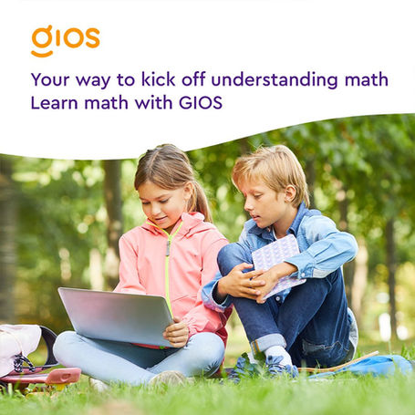 a boy and a girl sit on the grass looking at a laptop