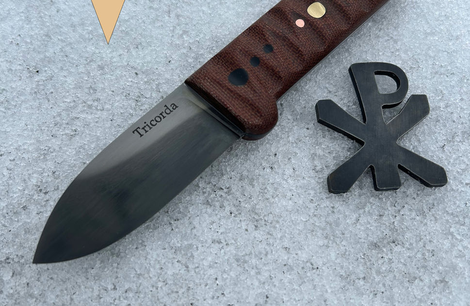 small knife with brown handle and Christogram